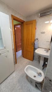 a bathroom with a toilet and a sink at 009 Bungalow La Mata in La Mata
