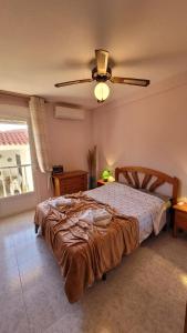 a bedroom with a bed and a ceiling fan at 009 Bungalow La Mata in La Mata