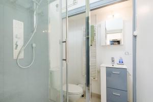 a bathroom with a shower and a toilet and a sink at Appartement Dans Villa in Villeneuve-Loubet +16 photos