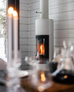 a fireplace in a room with a person in it at Polaris Villas - Villa Deluxe in Muonio