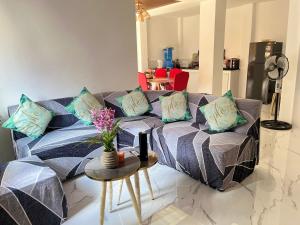 a living room with a couch and a table at Loven Transient House in Dauis