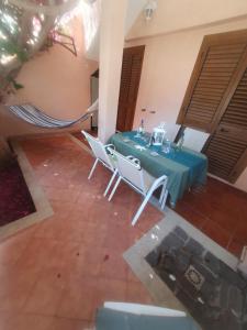 a blue table and chairs in a room at La Bouganville in Villasimius