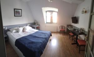 Postel nebo postele na pokoji v ubytování Abbázia Club Hotel Kék