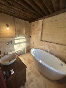 a bathroom with a large tub and a sink at Bella vista stone house in Urgup +42 photos