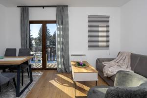 a living room with a couch and a table at Vila Golijat in Raška