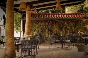 a patio with tables and chairs in a restaurant at Hotel Bela Roza in Bijela