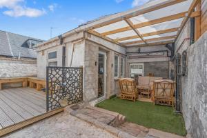 a patio with a table and chairs on a deck at Long Stay Sheffield 4Beds Contractor Ideal 5Guests in Walkley