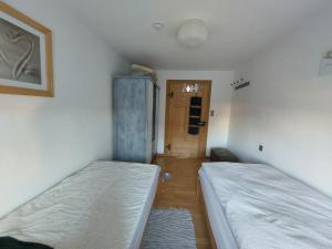 a room with two beds and a hallway with a door at Ferienwohnung - Das Boarding House in Lemgo