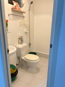 a white bathroom with a toilet and a sink at Loven Transient House in Dauis +14 photos