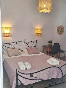a bedroom with a bed with towels on it at Vithos in Agnontas