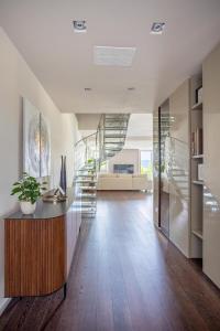 a hallway with a spiral staircase in a house at BePlace Apartments Arona in Arona