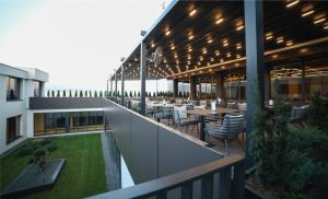 an outdoor patio with tables and chairs on a building at Tsar Samuil Hotel in Strumica +87 photos