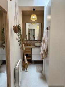 a bathroom with a sink and a mirror at La parenthèse balinaise in Cholet +7 photos