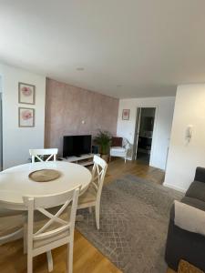 a living room with a white table and chairs at Casa de Sao Tiago 1 in Funchal