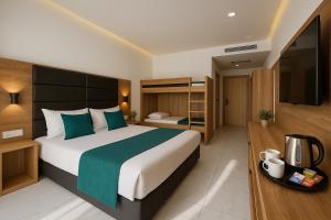 a hotel room with a large bed and a television at Hotel Babylon Royal in Ringsheim