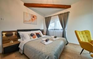 a bedroom with a bed and a yellow chair at Modern Home With Pool And View in Popovača