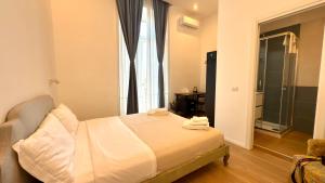 a bedroom with a bed and a large window at Izz Home in Naples