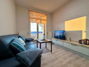 Μια τηλεόραση ή/και κέντρο ψυχαγωγίας στο Haus Concordia I Ferienwohnung 5 im Haus Concordia