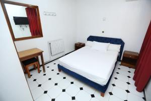 Postel nebo postele na pokoji v ubytování Raiss Hotel