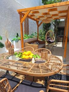 a table and chairs with a plate of fruit on it at Vithos in Agnontas