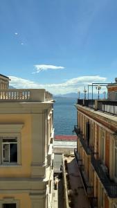 a view of the ocean from between buildings at Izz Home in Naples