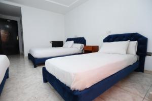 Postel nebo postele na pokoji v ubytování Raiss Hotel
