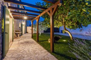 a pergola in the backyard of a house at Villa Katja near Pula with whirlpool only 3 km from the beach in Krnica