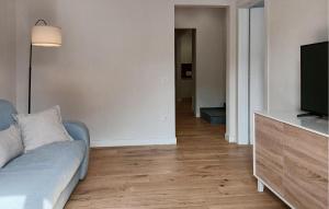 a living room with a couch and a flat screen tv at 1 Bedroom Nice Apartment In Casalguidi in Cantagrillo +3 photos