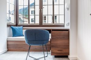 a room with a chair in front of a window at Hotel Mondschein in Innsbruck +59 photos