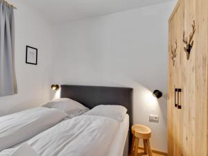 A bed or beds in a room at Modern Chalet in Mühlbach am Hochkönig near Ski Area