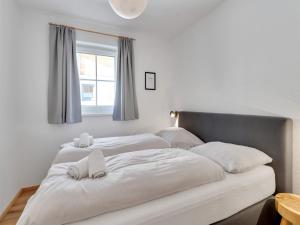 A bed or beds in a room at Modern Chalet in Mühlbach am Hochkönig near Ski Area