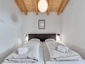 A bed or beds in a room at Modern Chalet in Mühlbach am Hochkönig near Ski Area