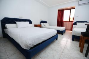 Postel nebo postele na pokoji v ubytování Raiss Hotel