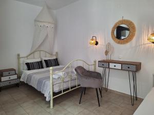 a bedroom with a bed and a desk and a mirror at Vithos in Agnontas