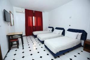 Postel nebo postele na pokoji v ubytování Raiss Hotel
