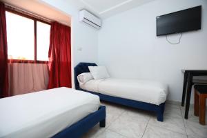Postel nebo postele na pokoji v ubytování Raiss Hotel