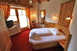 Postel nebo postele na pokoji v ubytování Hotel Garni San Nicolò