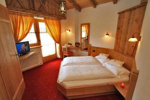 Postel nebo postele na pokoji v ubytování Hotel Garni San Nicolò