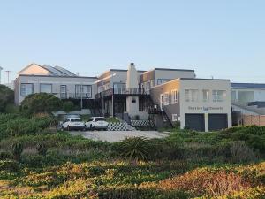 a group of houses with cars parked in a parking lot at Seaview Sunsets in Gqeberha