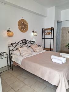 a bedroom with a large bed with white sheets at Vithos in Agnontas