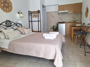 a bedroom with a large bed with towels on it at Vithos in Agnontas