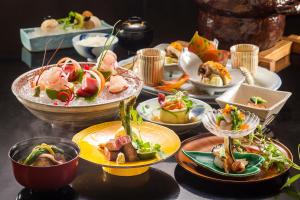 a table with many plates of food on it at Ryoutei Ryokan Yasui in Hikone