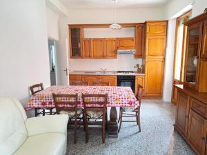 a kitchen with a table and chairs in a room at Dimora Martini in Montevarchi