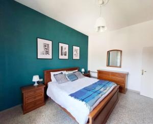 a bedroom with a bed and a green wall at Dimora Martini in Montevarchi
