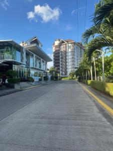 an empty street in front of some buildings at The Infinity View in Talisay