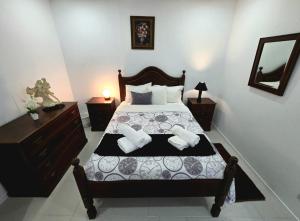 a bedroom with a bed with two pillows on it at The Cedar Tree House in Sete Cidades