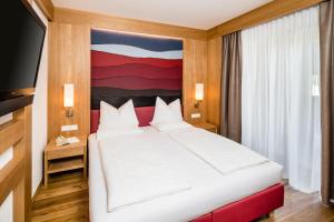 Postel nebo postele na pokoji v ubytování Hotel Hasslhof