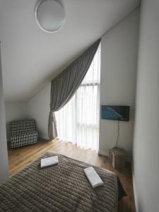 a bedroom with a bed and a large window at SeasideSpa appartment Jakuzzi Swimming pool in Palanga