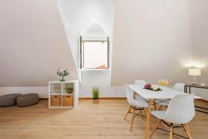 a white living room with a table and chairs at Nati by KAAMAH in Ribeira Brava +14 photos