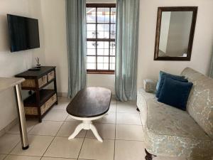 a living room with a couch and a chair at Montana Cape House in Pretoria